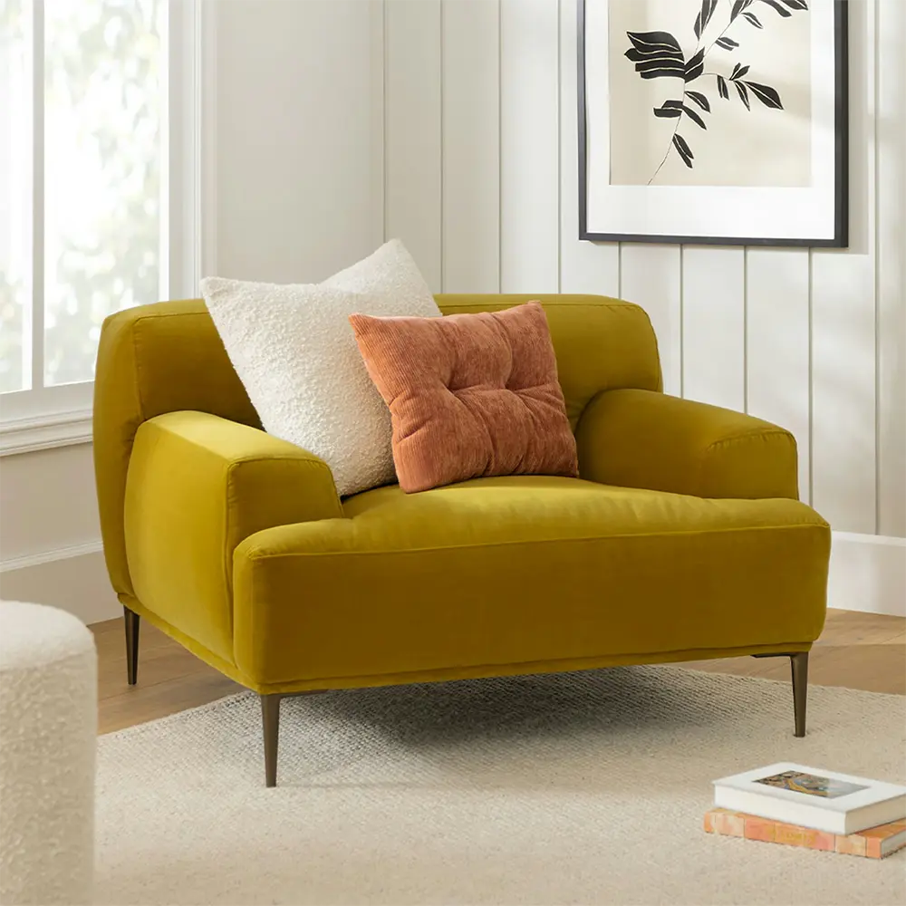 Yellow armchair with decorative pillows in a living room setting