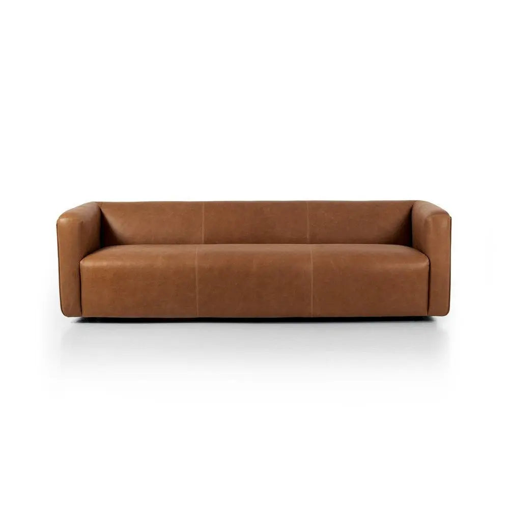 Brown leather sofa with sleeky features in living room setting.