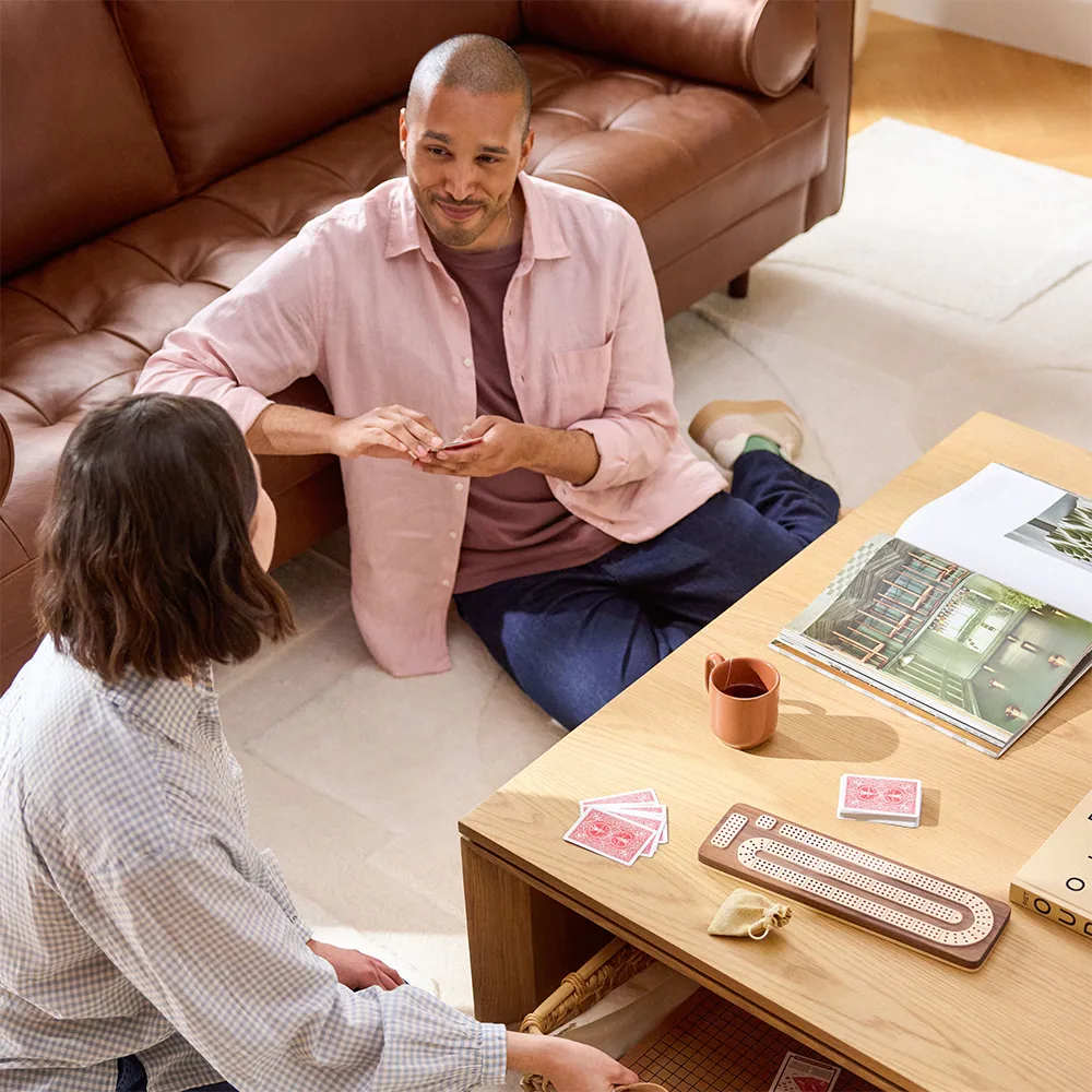 Brown sectional sofa and a wooden table in a living room.