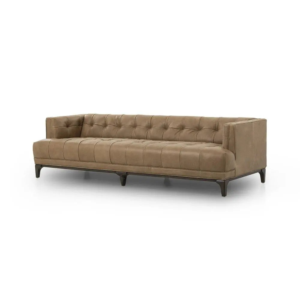 Brown sofa with tufted style in sitting space setting.