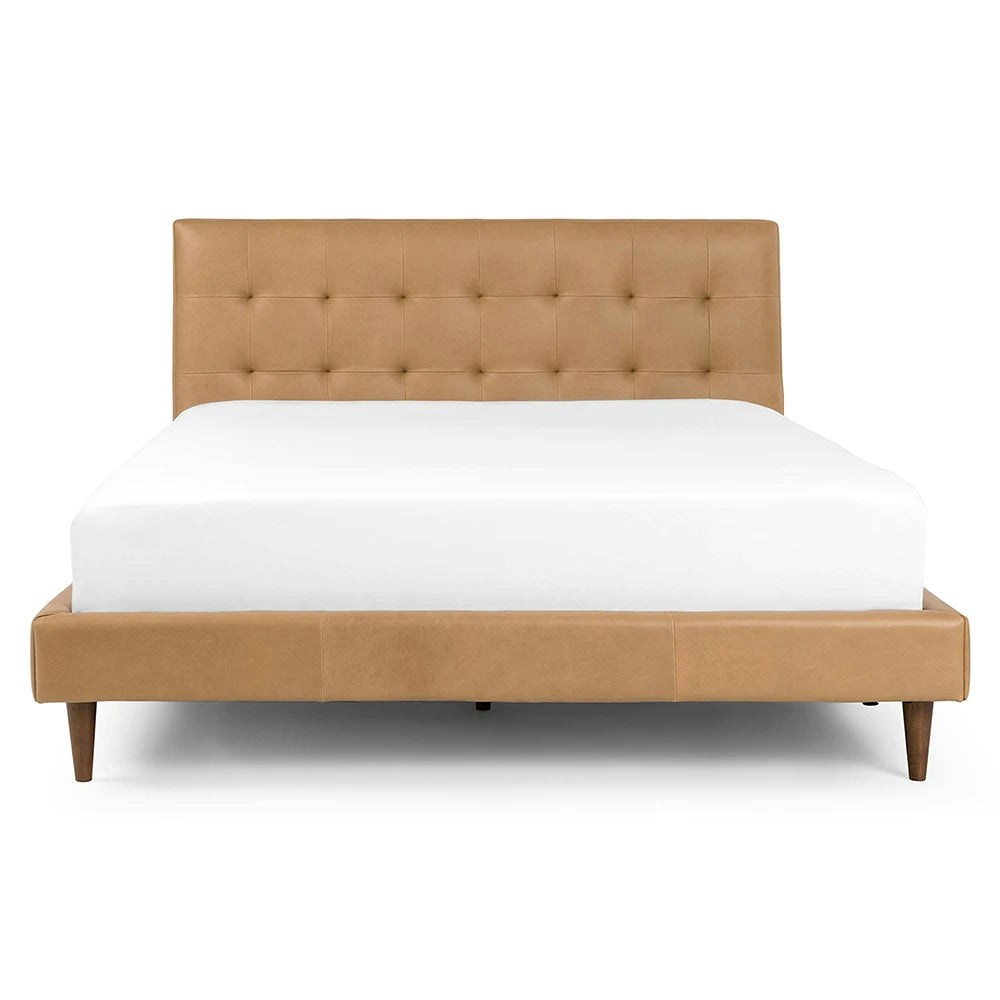 Tan upholstered bed with white mattress on a white background