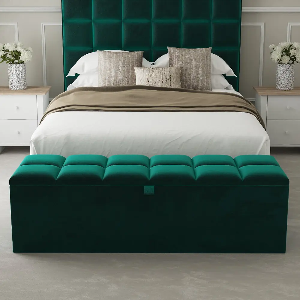 Green upholstered ottoman in front of a stylish bed in bedroom.