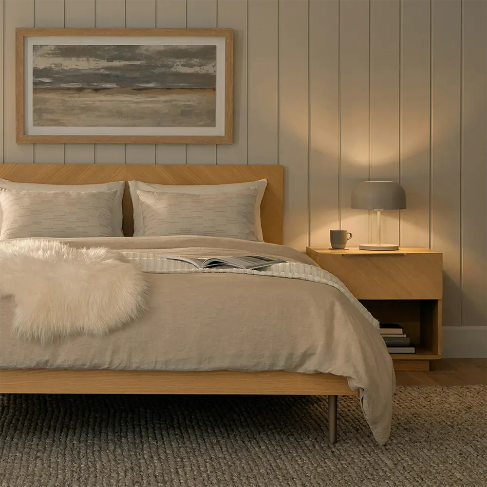 Cozy bedroom with wooden bed and nightstand.