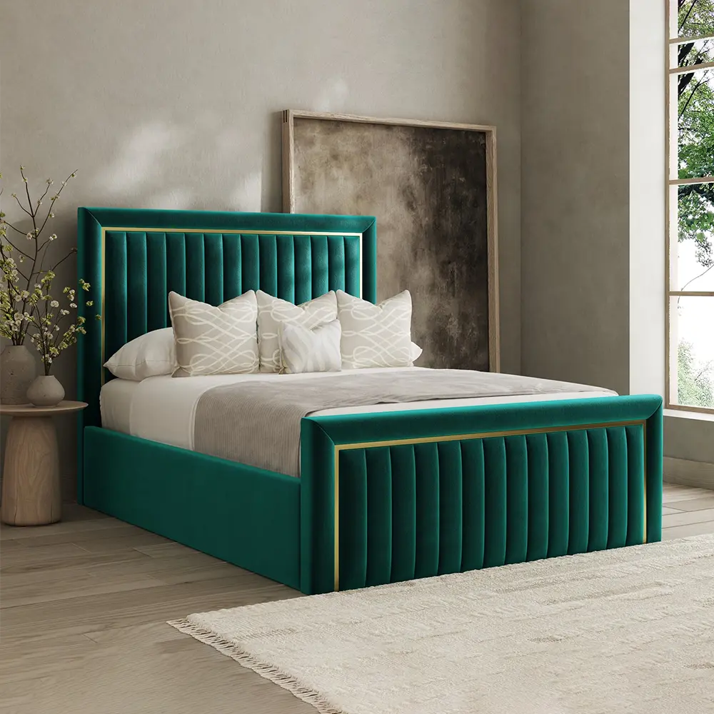 Green velvet bed with white bedding in a room with a large window.