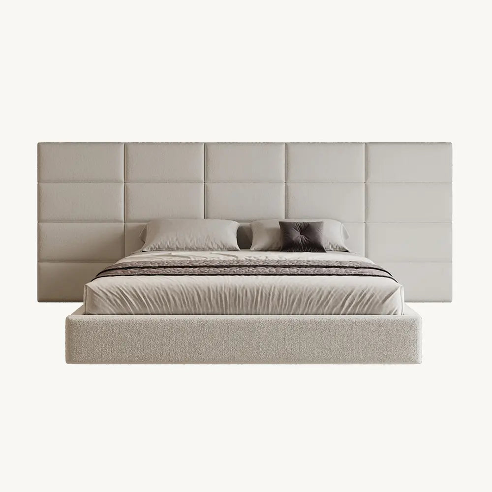 Beige upholstered bed with matching headboard in modern bedroom.