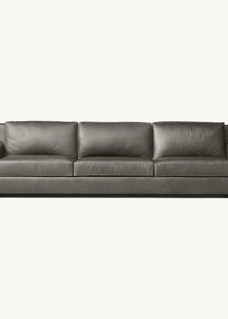 Gray leather sofa with stylish finish in living room.