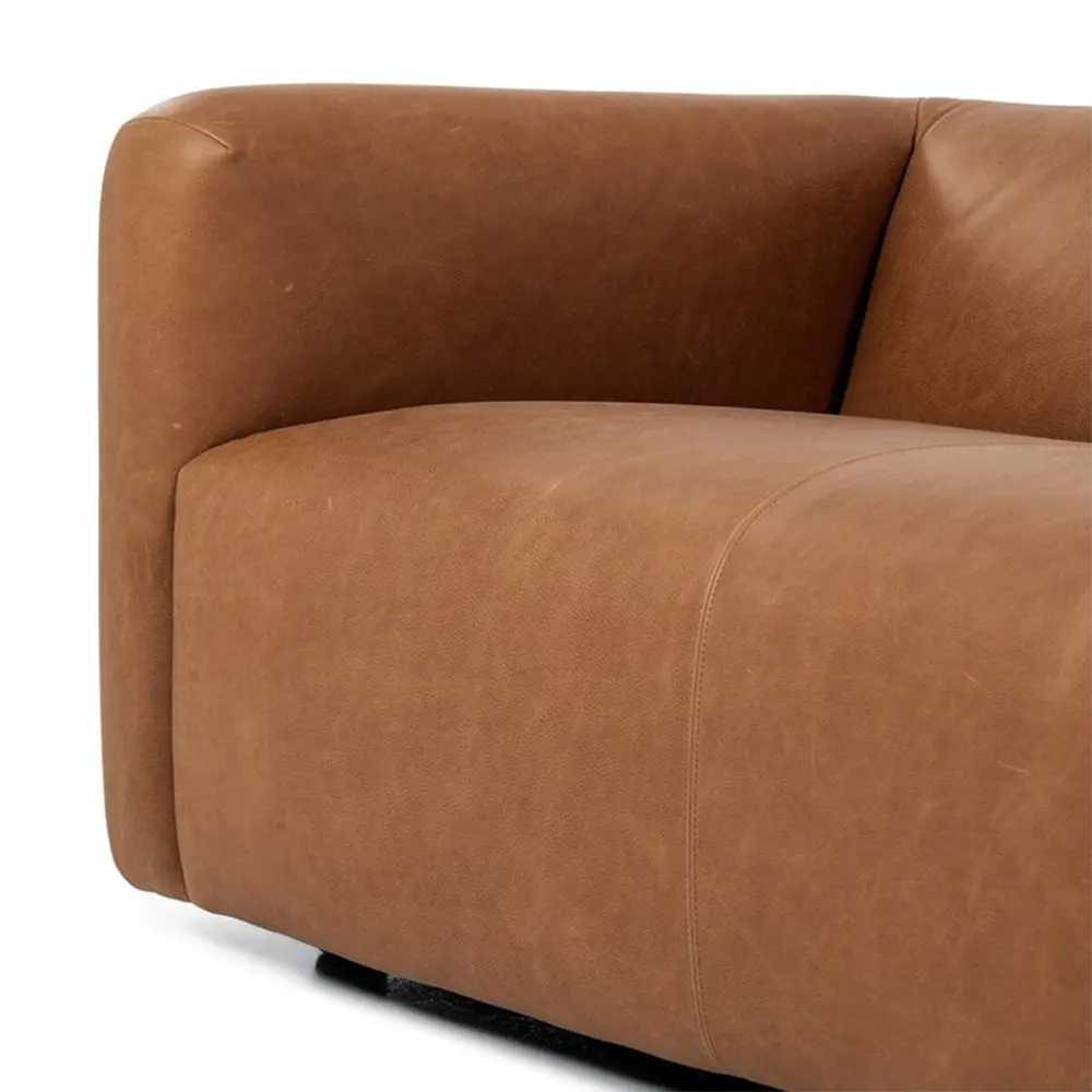 Brown leather sofa corner close-up in modern lounge.