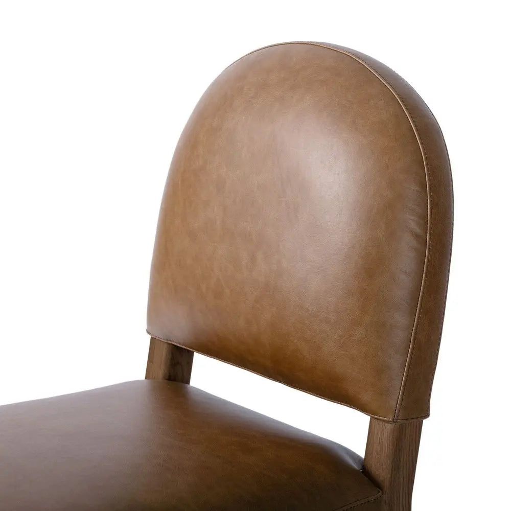Brown leather chair back with soft texture.