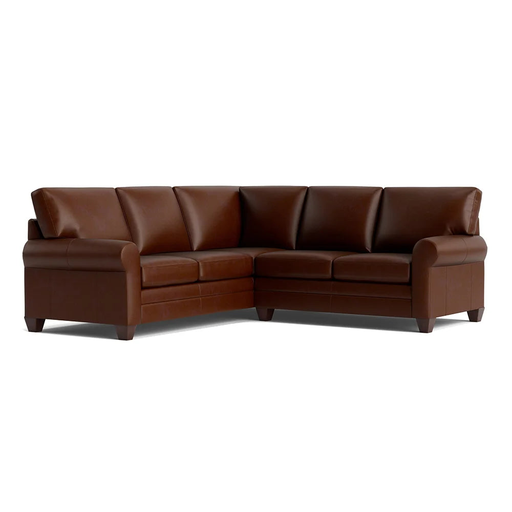 Brown leather sectional sofa in living room setting.