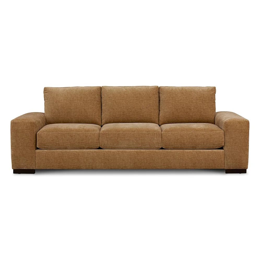 Brown sofa with fabric upholstery in living room.