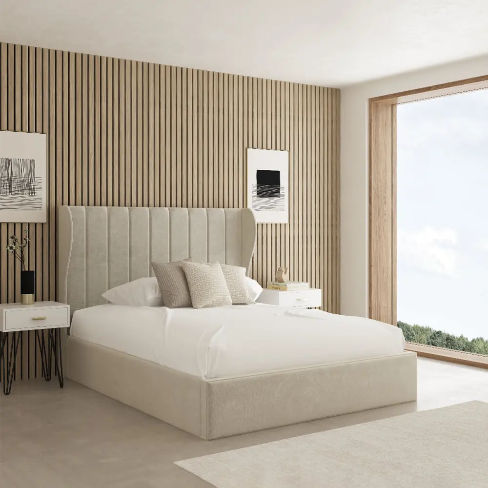 Modern bedroom with a beige upholstered bed against a striped wall.