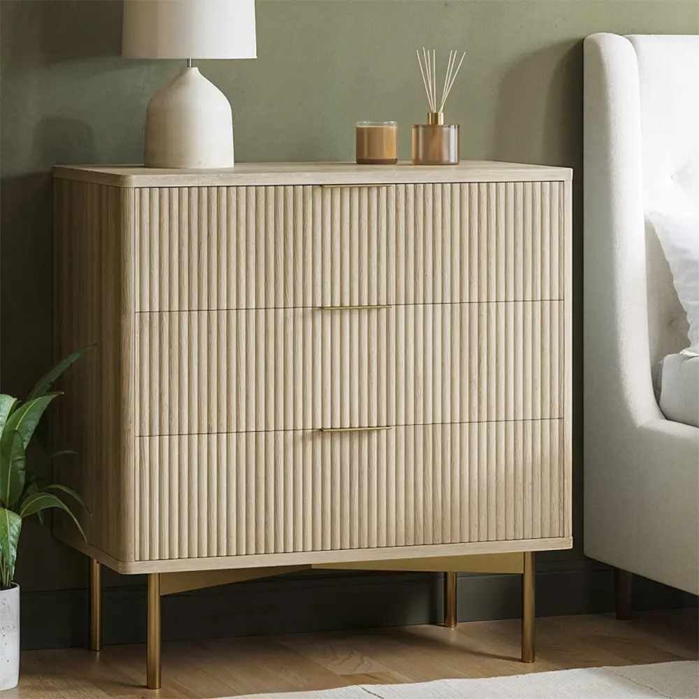 Beige dresser with decorative items in a bedroom setting
