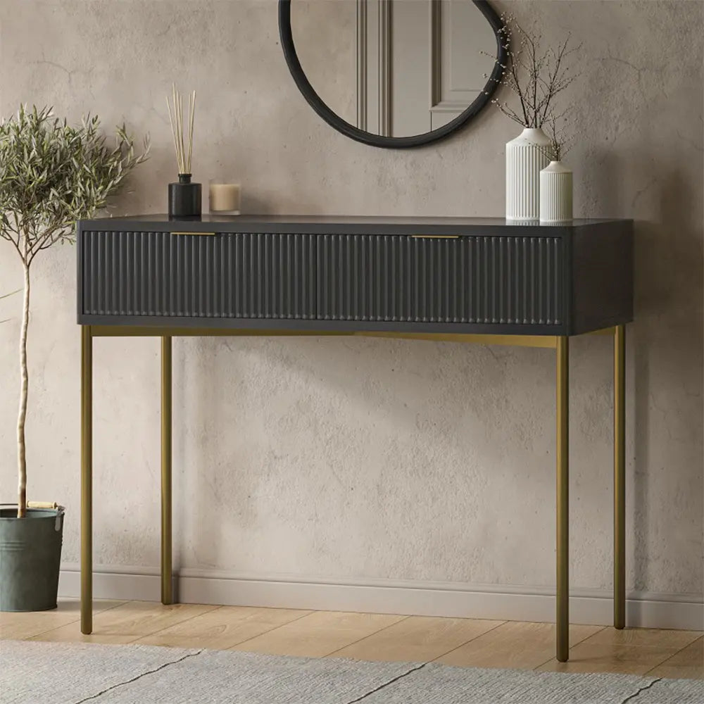 Console table with drawers and decorative items against a neutral wall