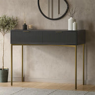 Console table with drawers and decorative items against a neutral wall