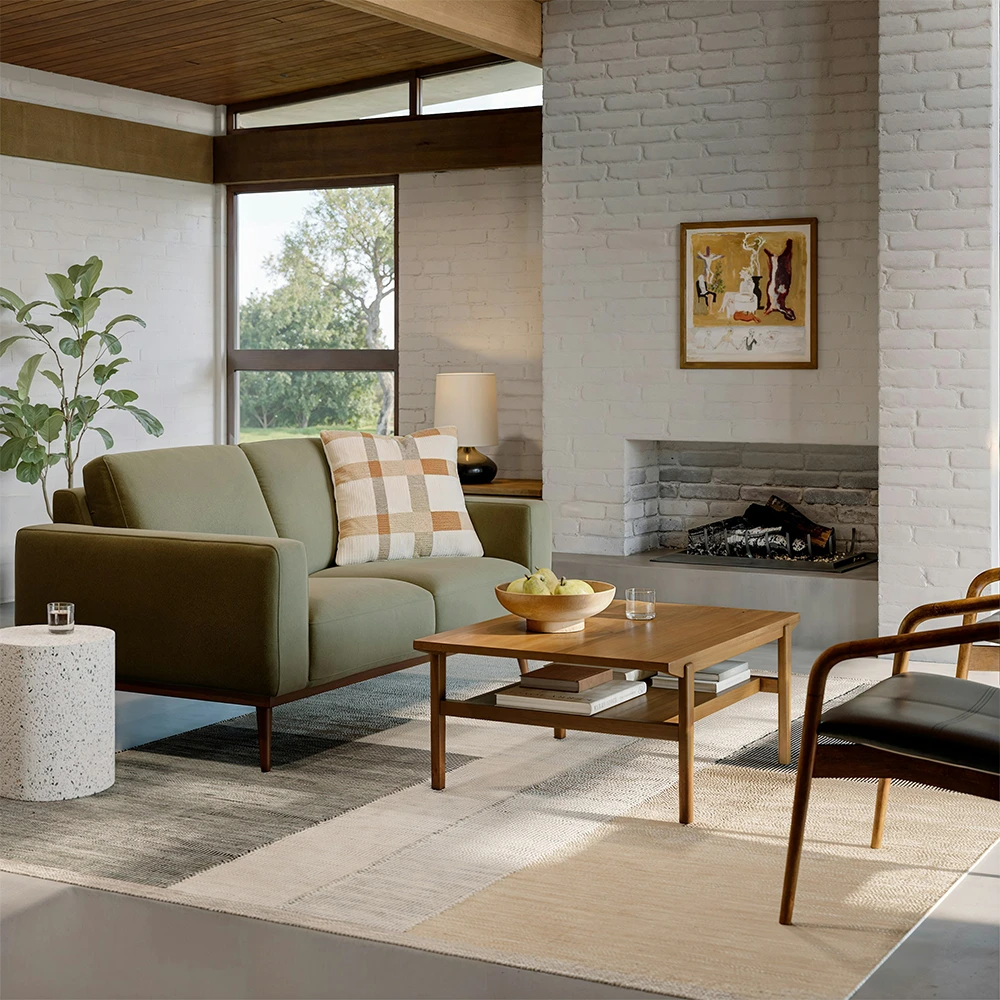 Modern living room with a sofa, coffee table, and chairs.