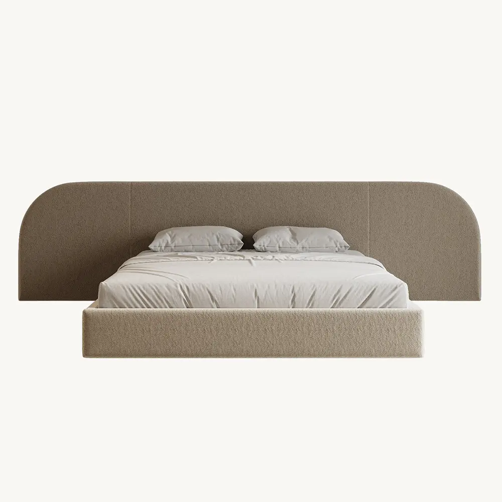 Beige upholstered bed with a white mattress and pillows on a white background