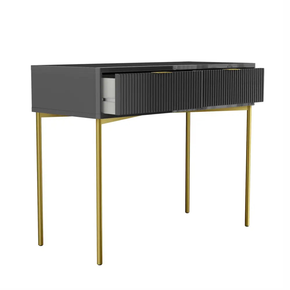 Modern console table with dark gray top and gold legs on a white background