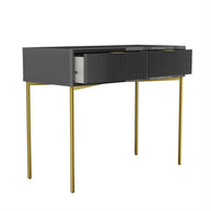 Modern console table with dark gray top and gold legs on a white background