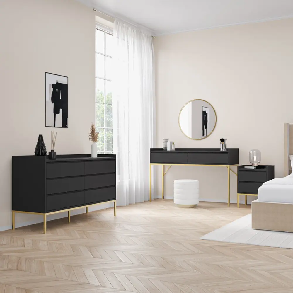 Modern bedroom with black dresser, vanity table, and white bed.