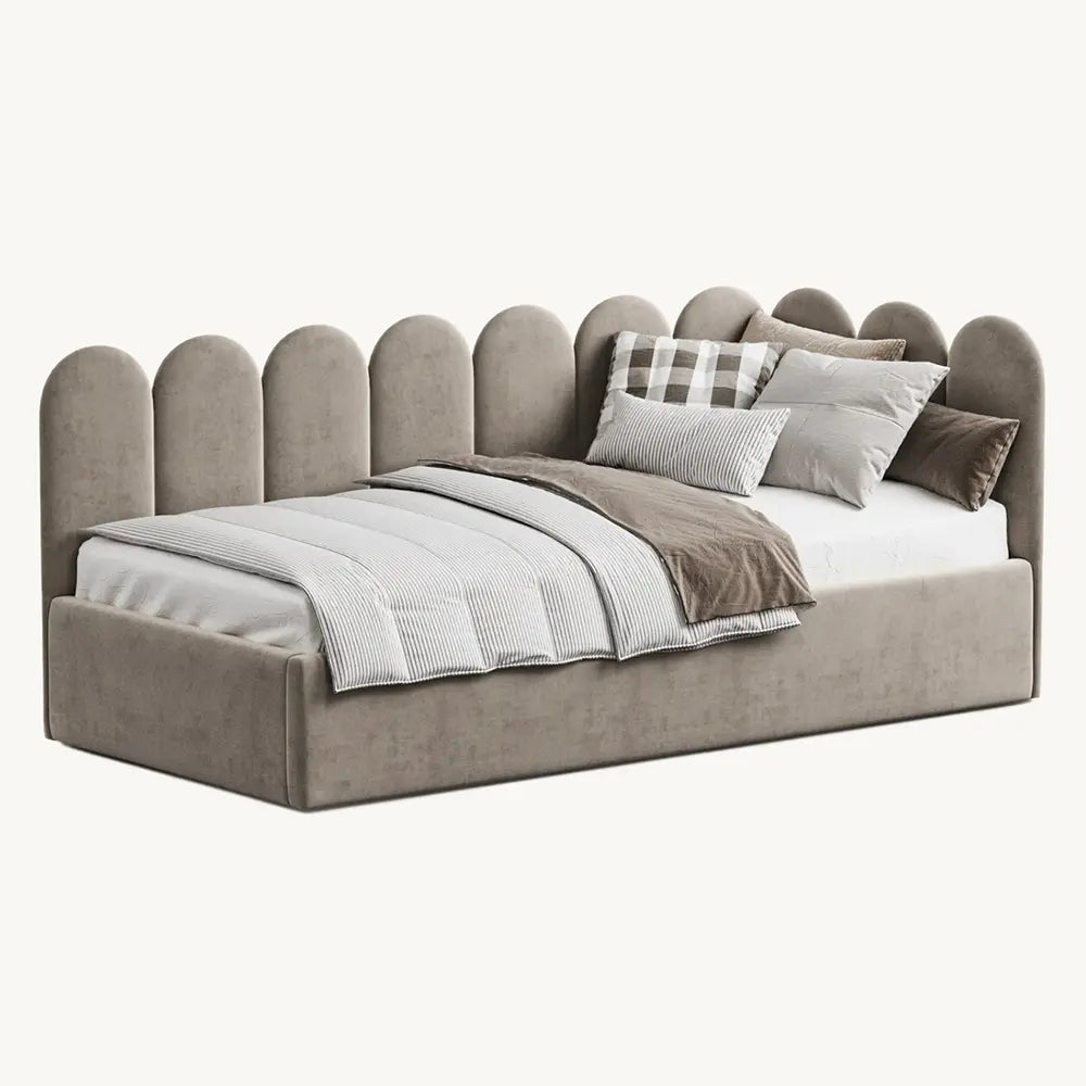 Beige upholstered bed with decorative pillows on a white background