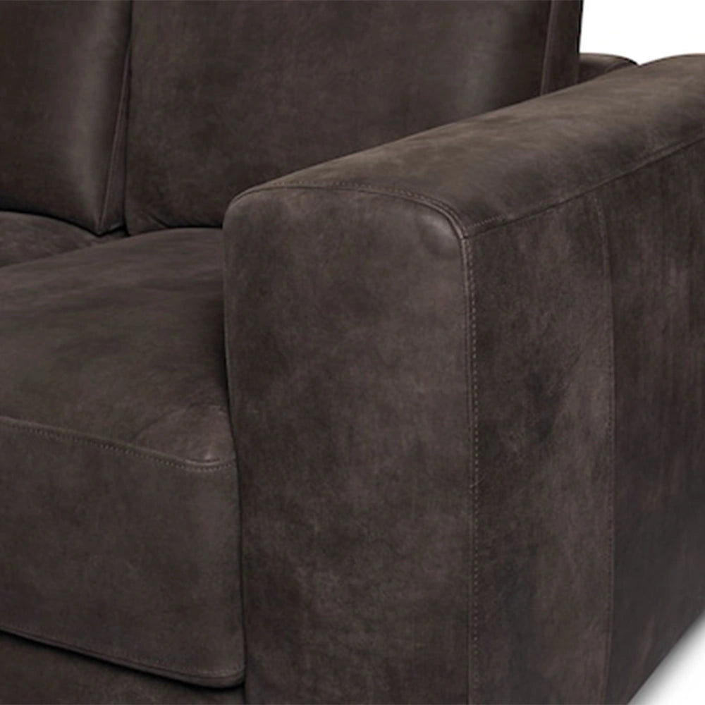 Close-up of a dark brown Jackson leather sofa with visible stitching.
