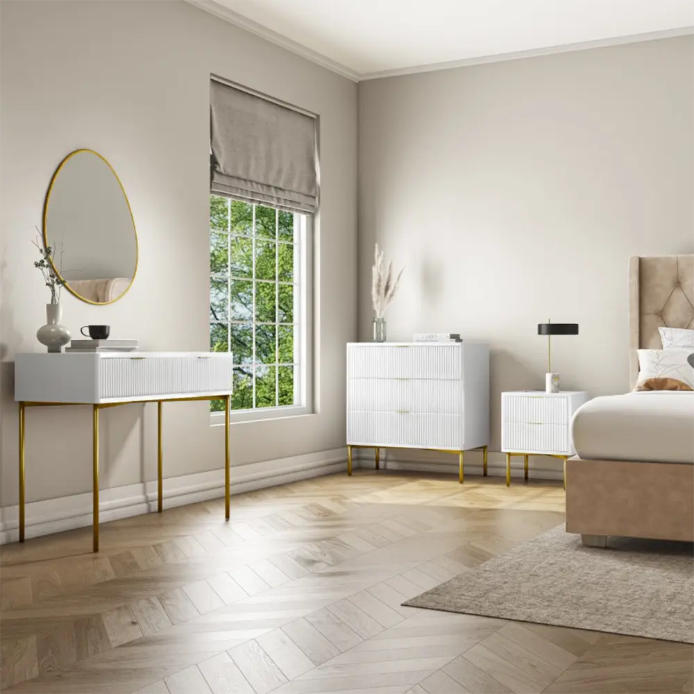 Modern bedroom with white furniture, gold legs, and a large window.