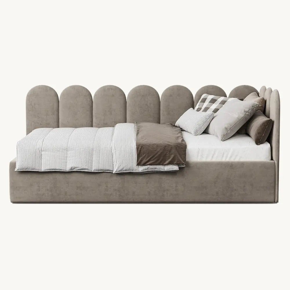 Gray upholstered bed with pillows and blankets on a white background