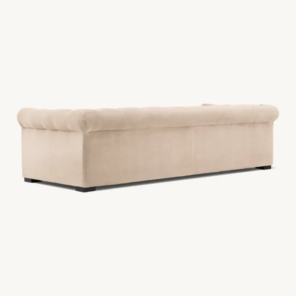 Beige sofa with stylish finish in lounge setting.
