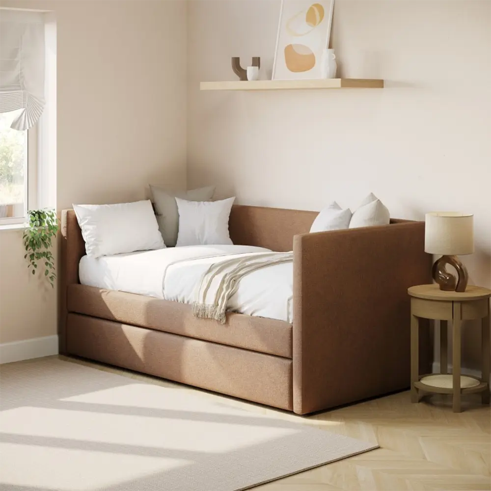 Brown upholstered bed with white bedding and pillows in a bright bedroom
