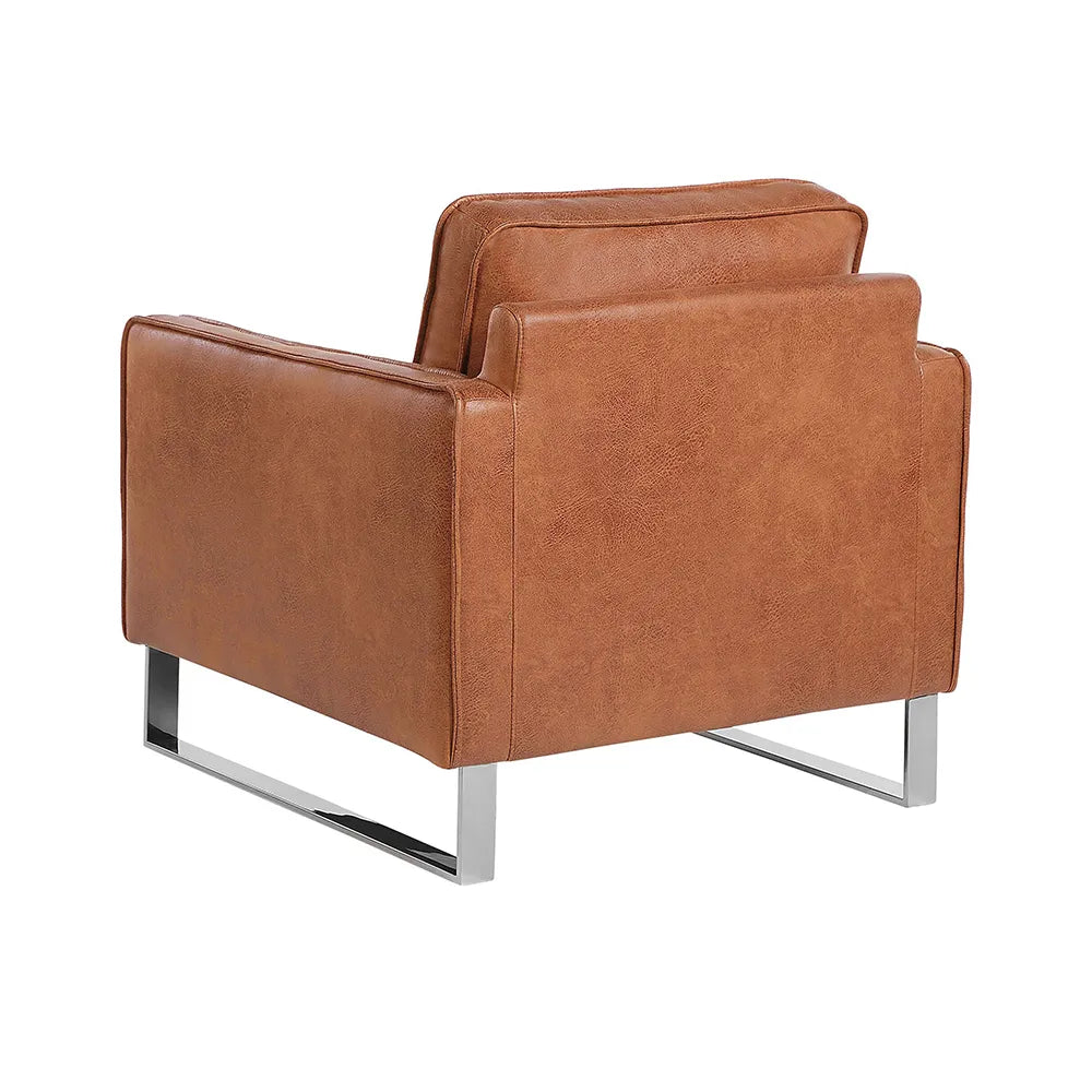 Brown leather armchair with metal legs in lounge.