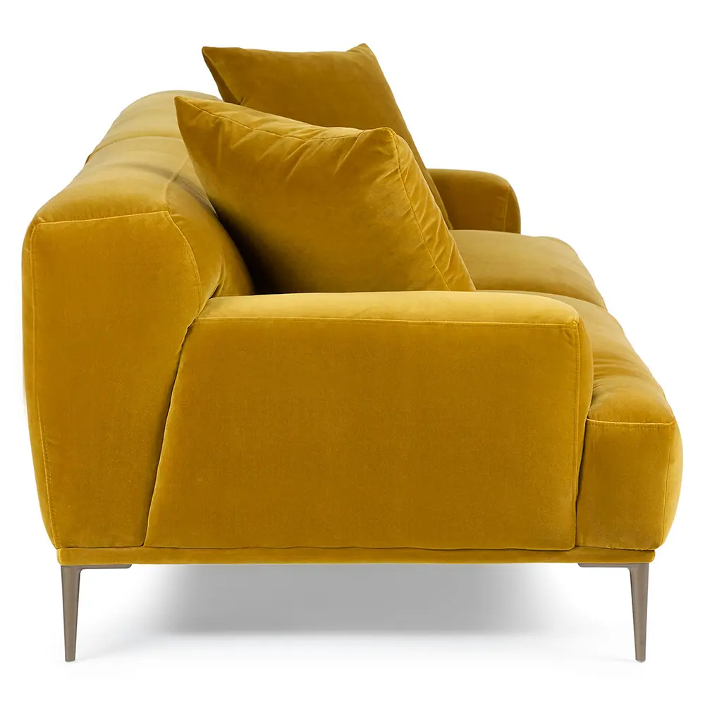 Yellow velvet sofa with cushions on a white background