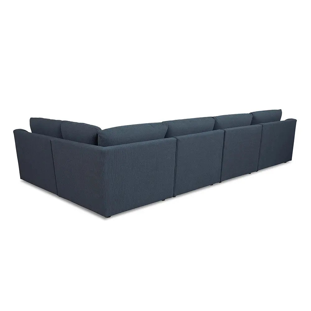 Long dark blue sectional sofa in sitting place setting.