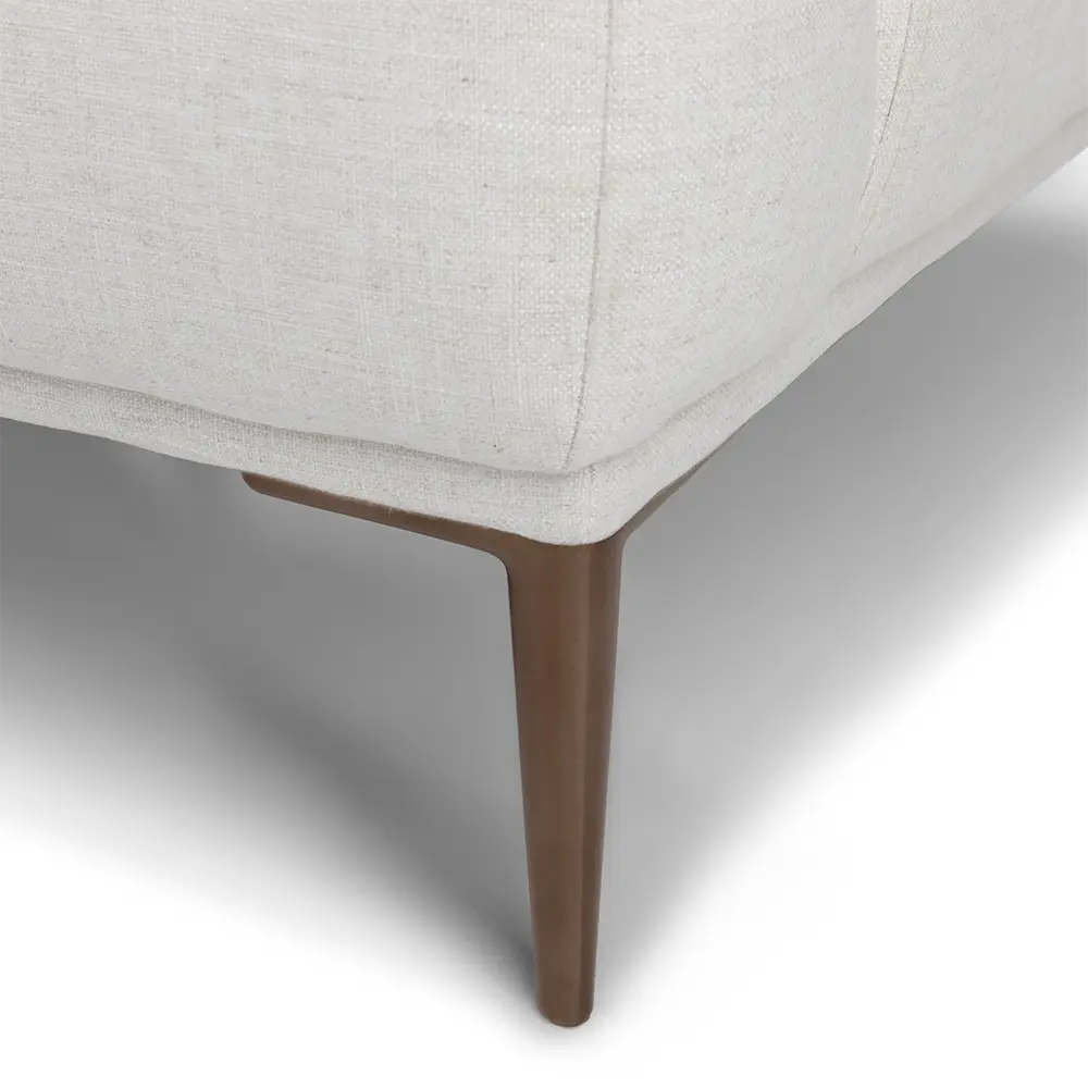 Close-up of a light gray upholstered chair with a wooden leg on a neutral background