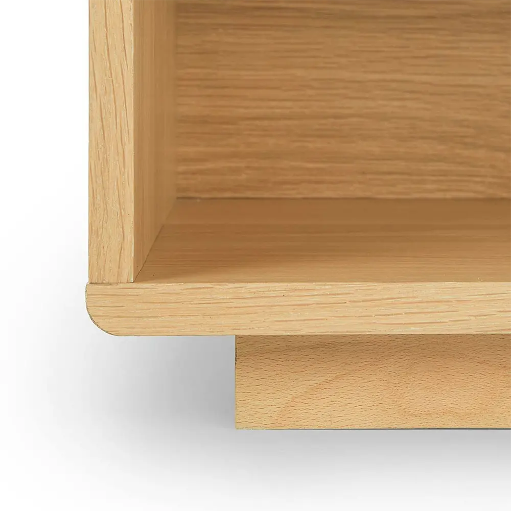 Close-up of a wooden side table with a light brown finish in bedroom.