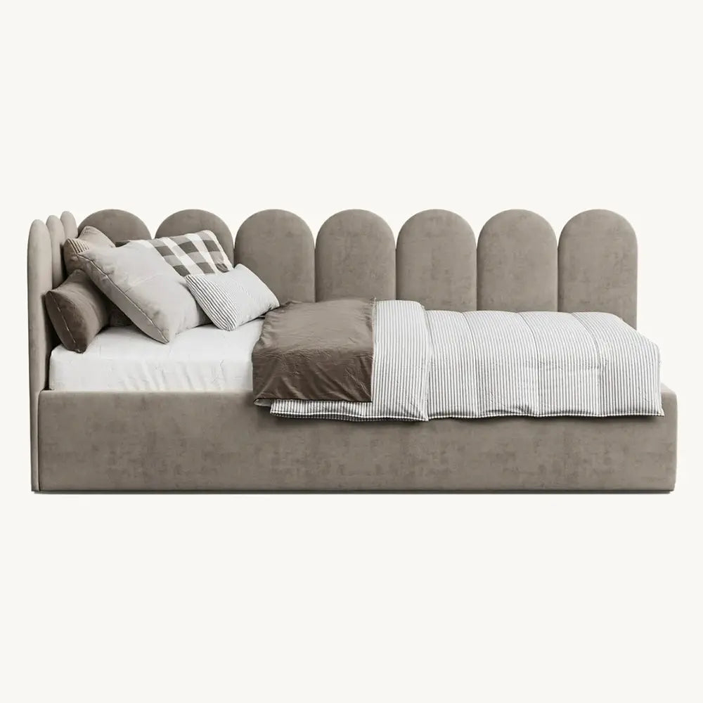 Gray upholstered bed with pillows and blankets on a white background