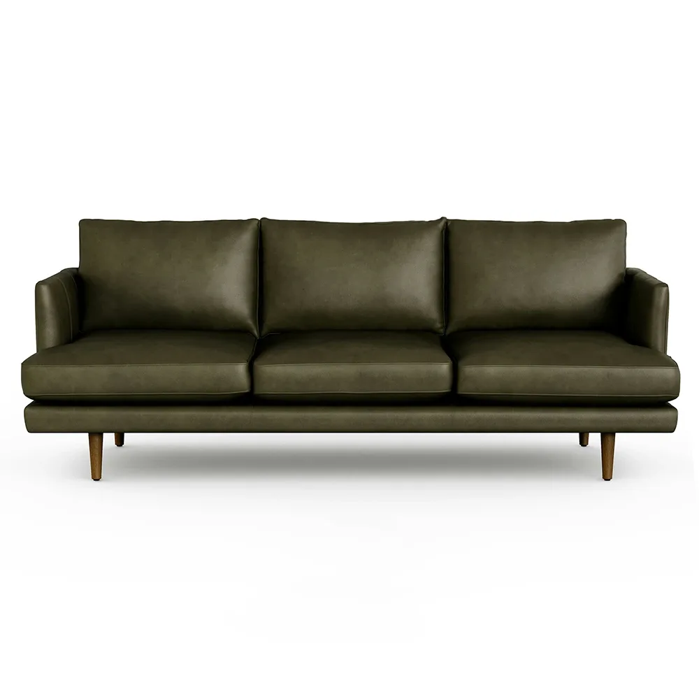 Stylish green leather sofa in modern living room setting.