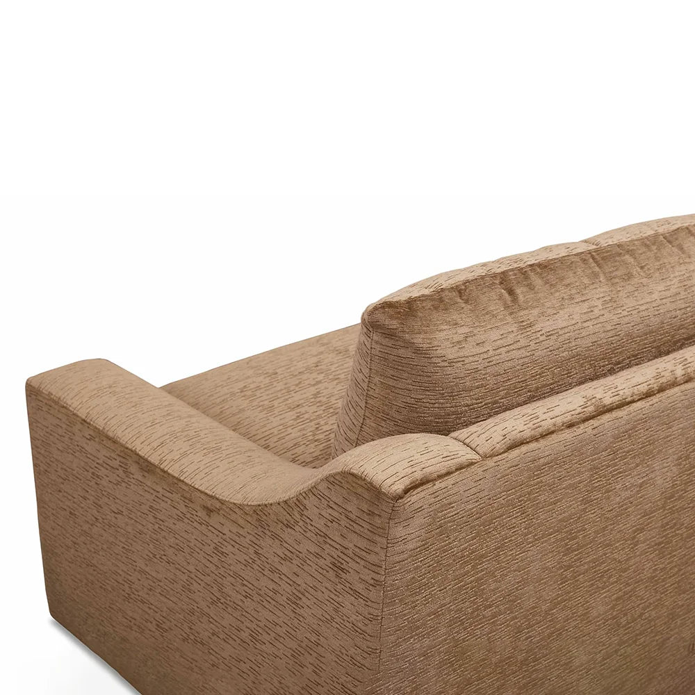 Close-up of a brown sofa with stylish finish in living room setting.