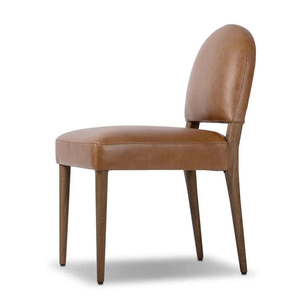 Brown leather chair with stylish frame in living room.