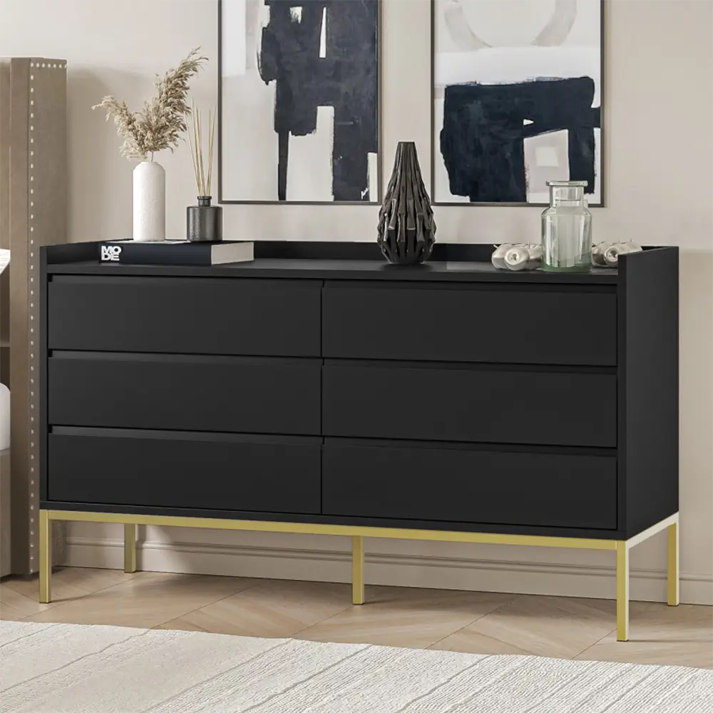 Black dresser with gold legs in a room setting
