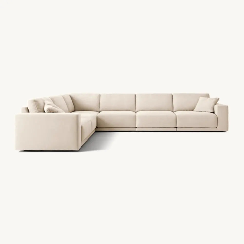 Beige sectional sofa with sleeky profile in lounge setting.