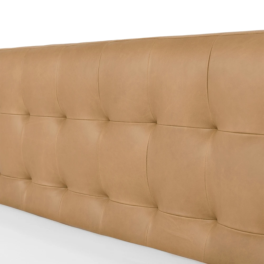 Brown leather tufted headboard on a white background