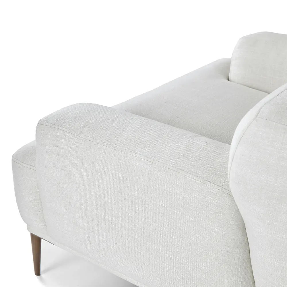 Light gray armchair with stylish legs in living room.