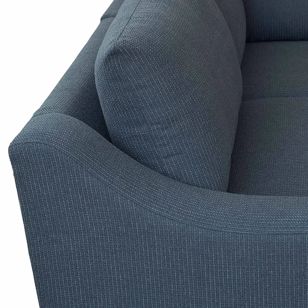 Close-up of a blue textured sofa with sturdy frame in lounge.