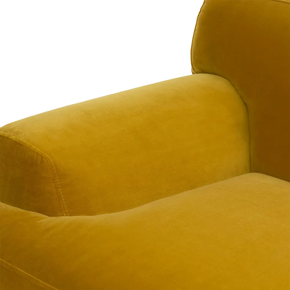 Close-up of a mustard yellow armchair in lounge.