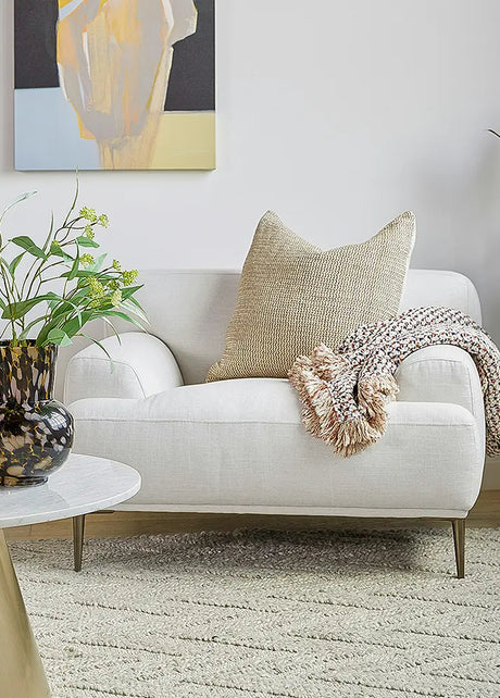 Modern living room setting with a white arm chair enhances sophistication.