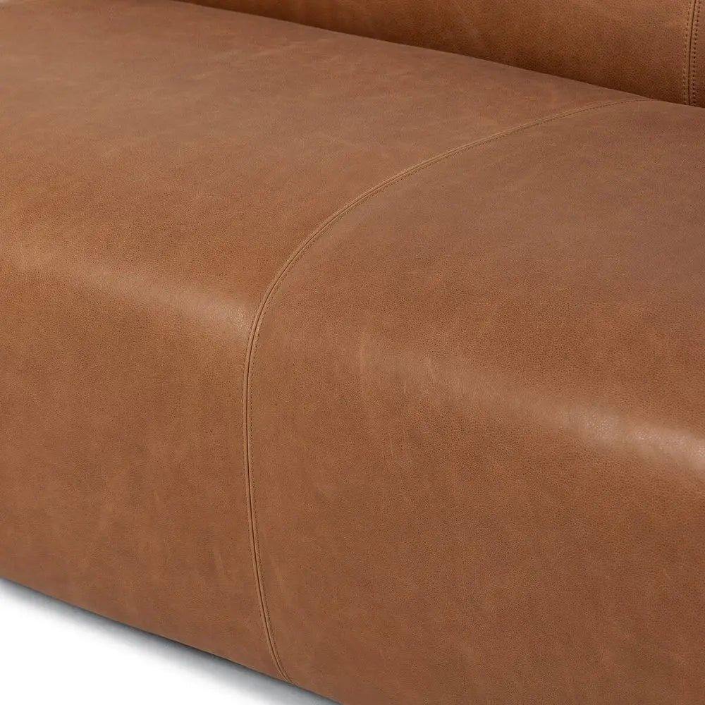 Close-up of a brown leather sofa.